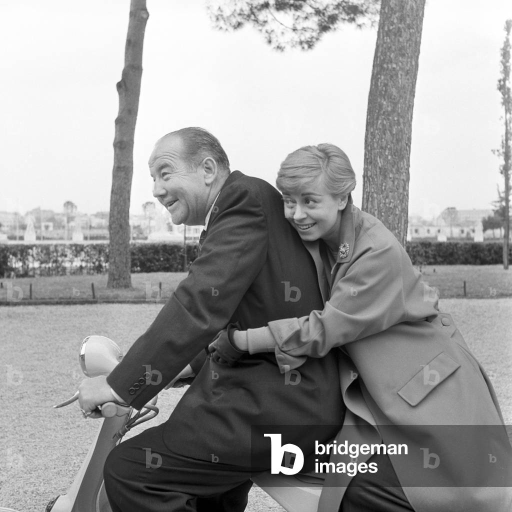 Giulietta Masina and Broderick Crawford on a vespa, Italy, 1957 (b/w photo)