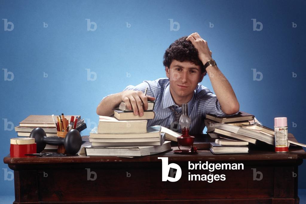 Portrait of Fabio Fazio seated at a table