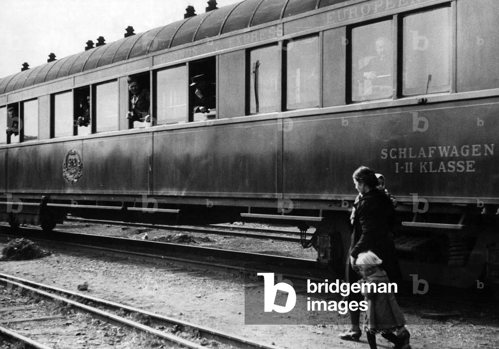 Woman with small children near a train, Ukraine