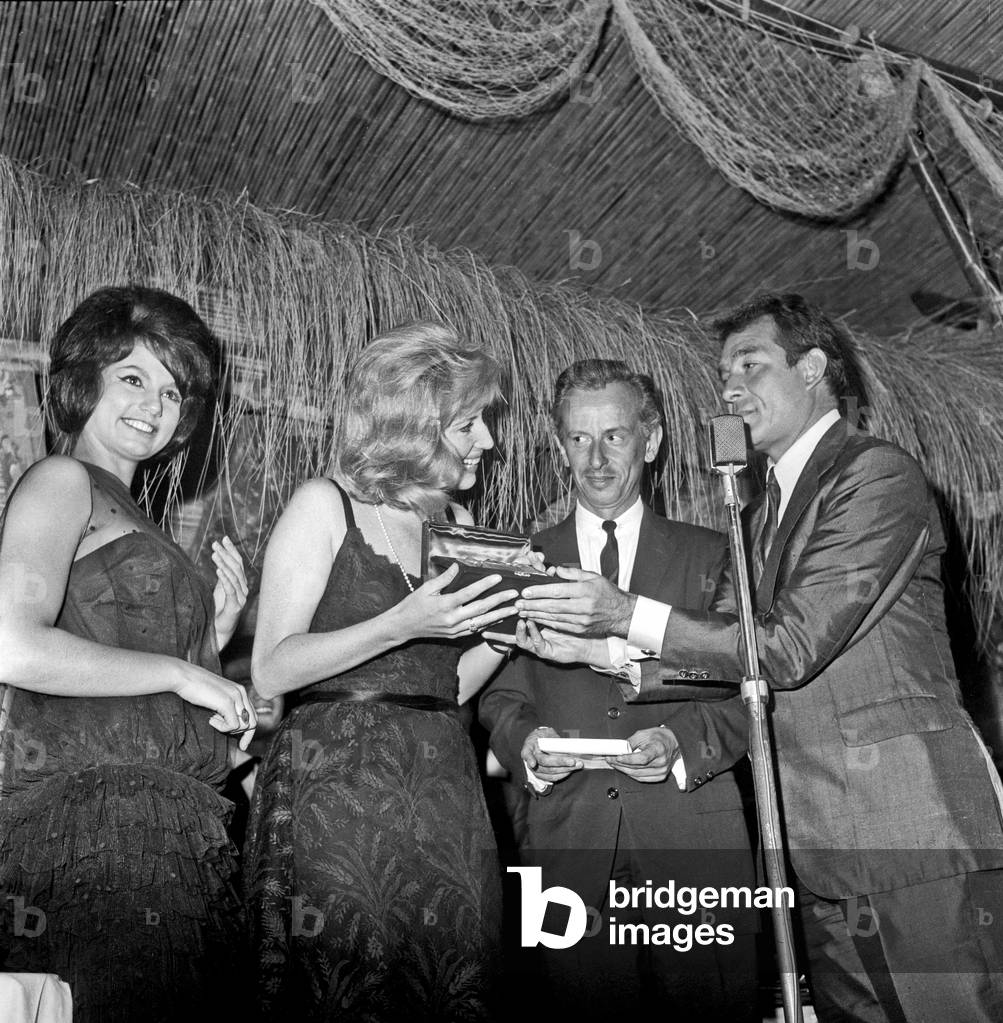 Monica Vitti getting 'Ciak d'oro' award from Ugo Tognazzi, Rome, Italy, 1961 (b/w photo)