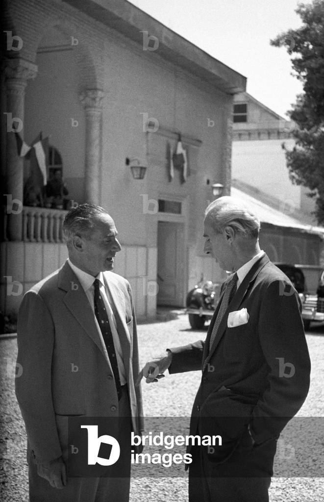 Enrico Mattei speaking with a man