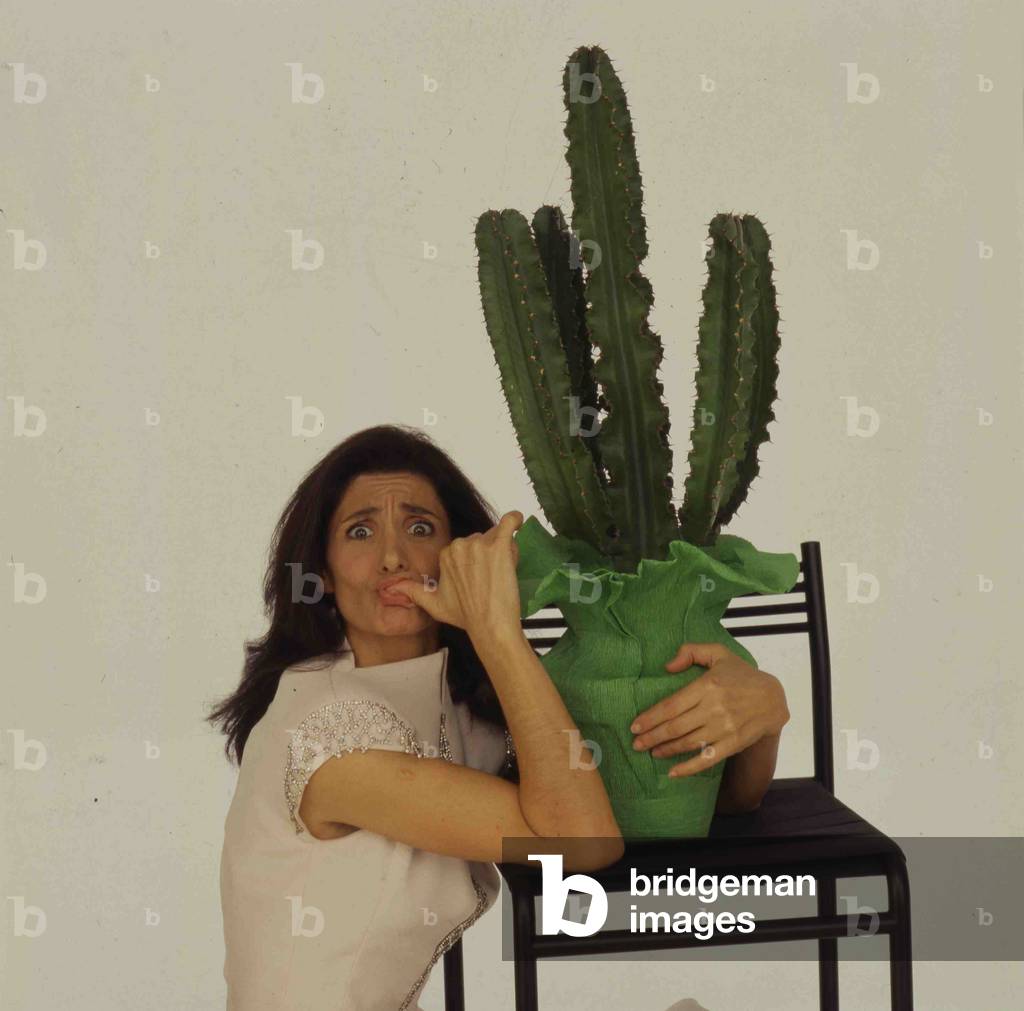 Anna Marchesini posing with a vase with a cactus, Italy, 1990 (photo)