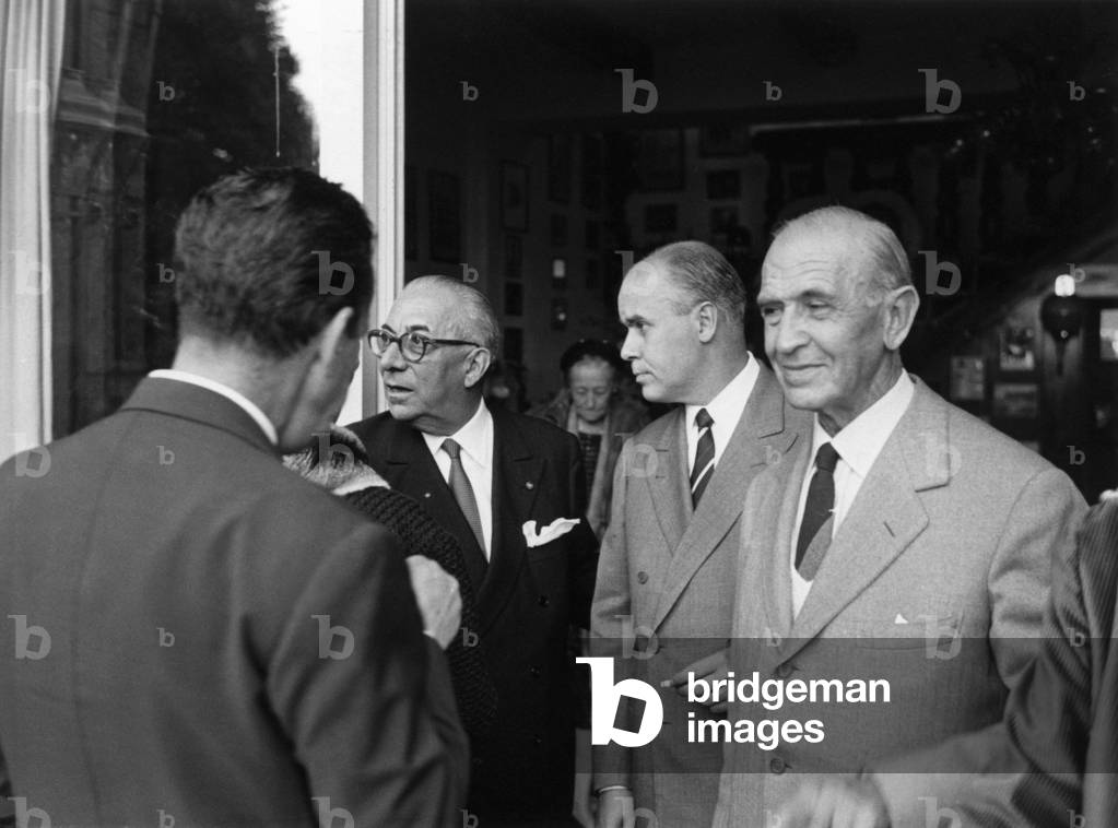 Italian publisher Arnoldo Mondadori celebrating his golden wedding with the director of Italian weekly magazine Epoca Nando Sampietro and Italian politician Dino Alfieri, Meina, October 1963 (b/w photo)