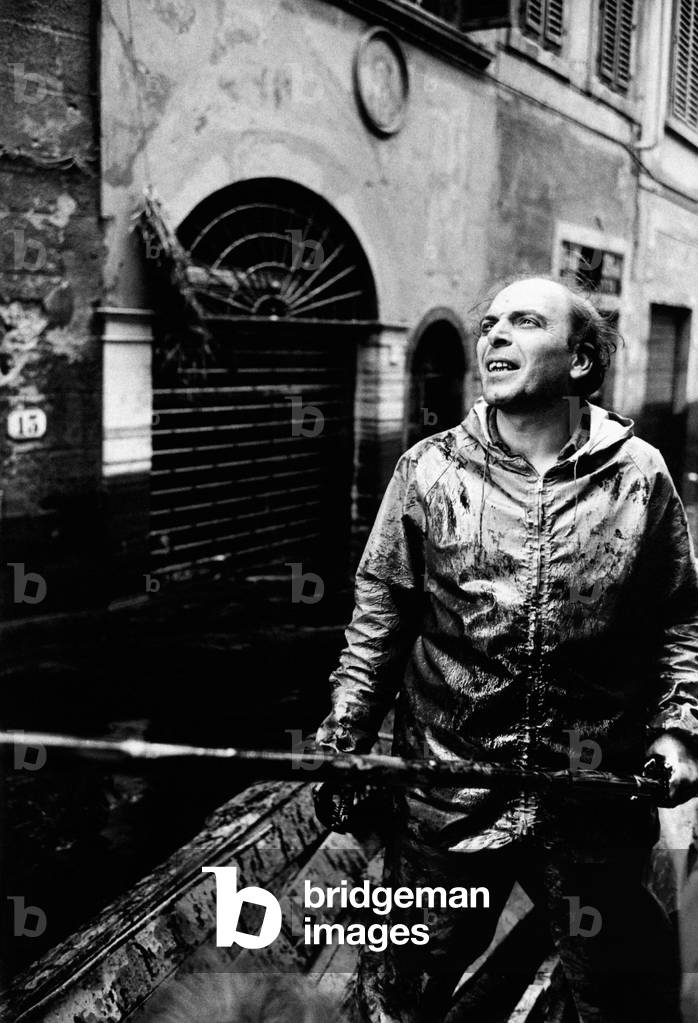 A man of the rescue squads at work in a flooded street
