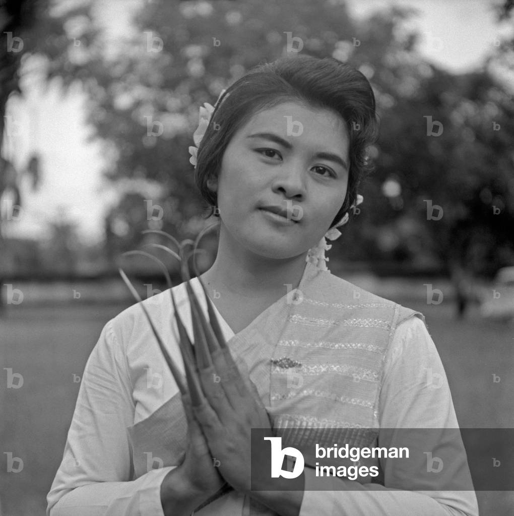 Young Thai woman wearing fake nails, Bangkok, 1961 (b/w photo)