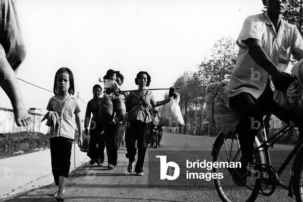 A group of refugees leaving Saigon, 1968 (b/w photo)