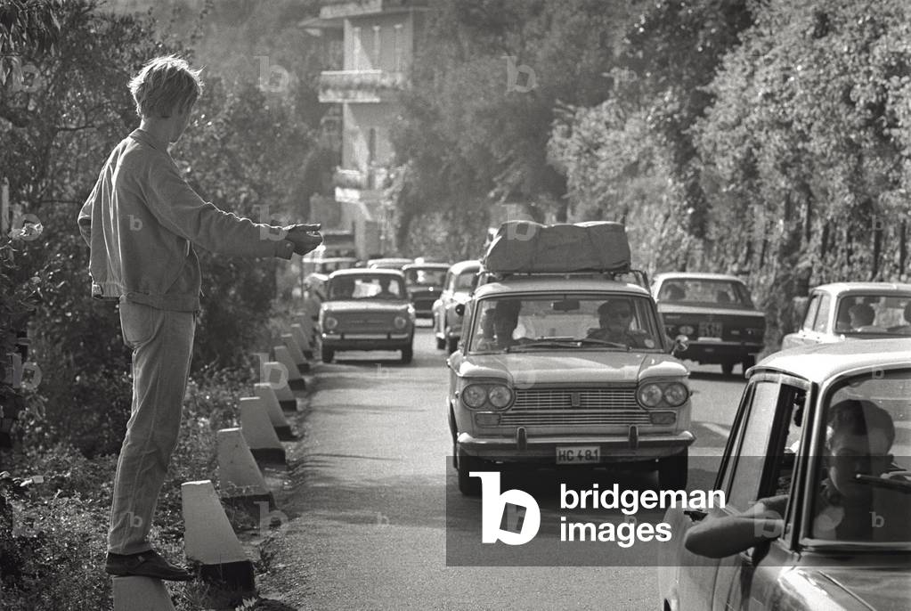 A young man hitchhiking in Chiavari