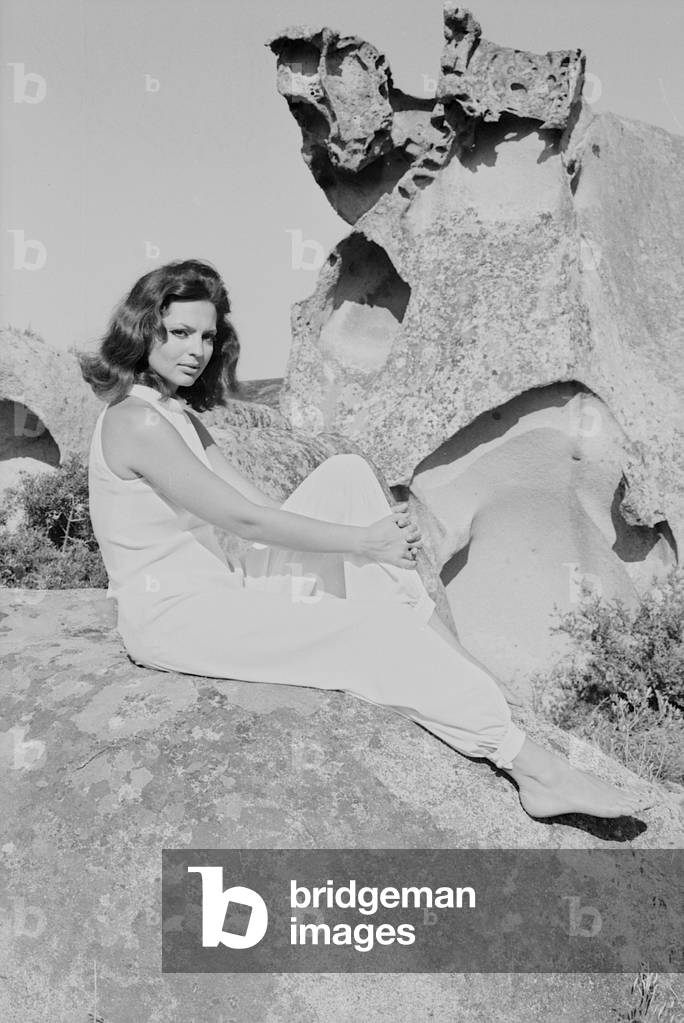 Ira von Fuerstenberg on a cliff in Porto Rotondo, Italy, 1967 (b/w photo)