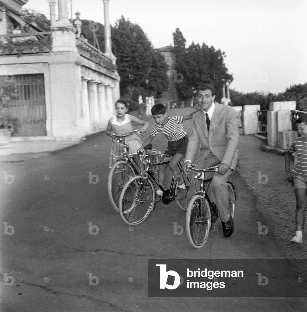 Pippo Baudo, italian tv host, bicycling, Italy, 1960 (b/w photo)