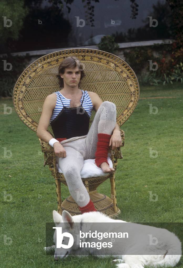 Miguel Bosé sitting in a chair, Italy