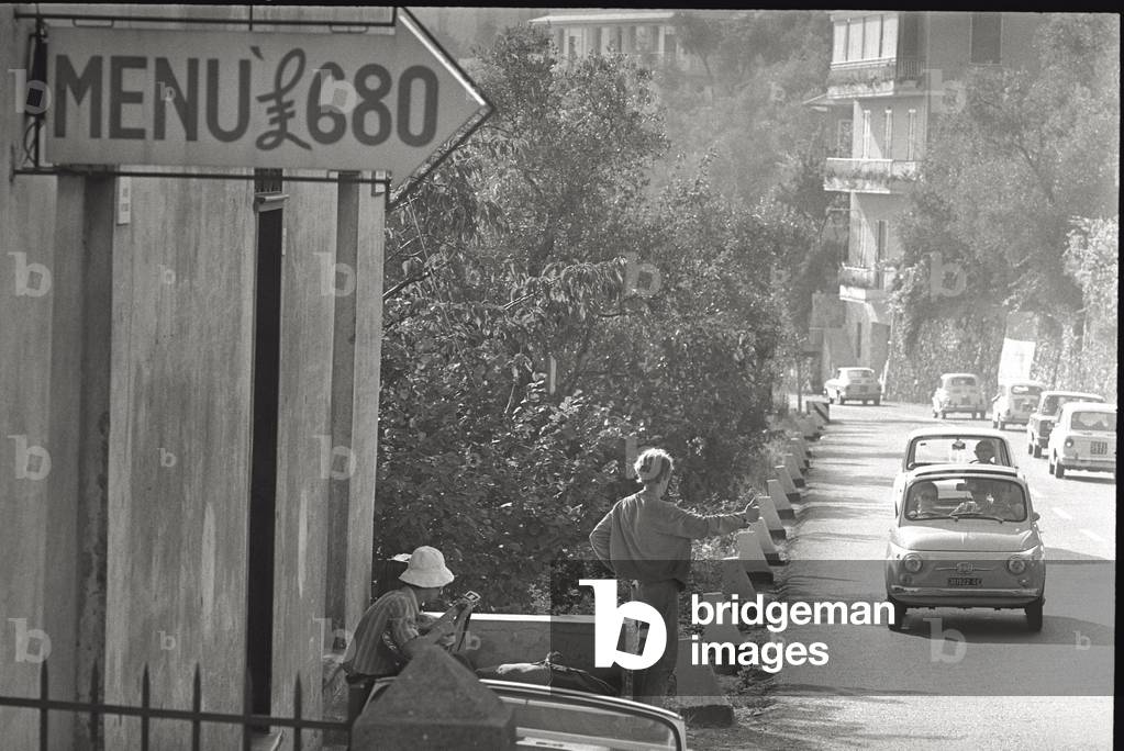 Two young men hitchhiking in Chiavari