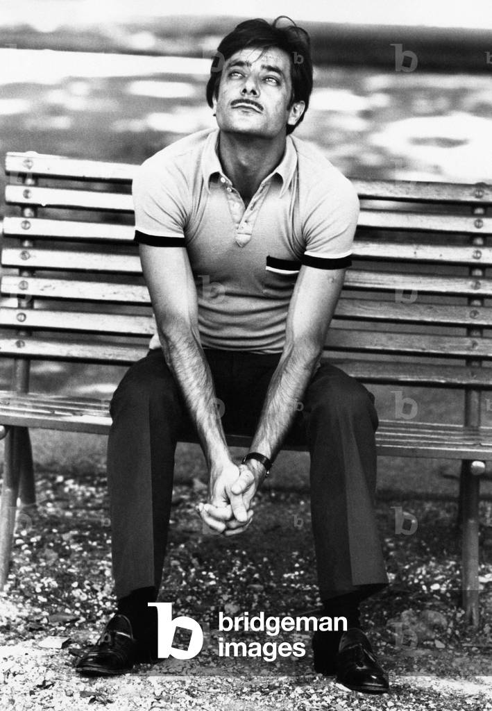 Portrait of Giancarlo Giannini sitting on a bench