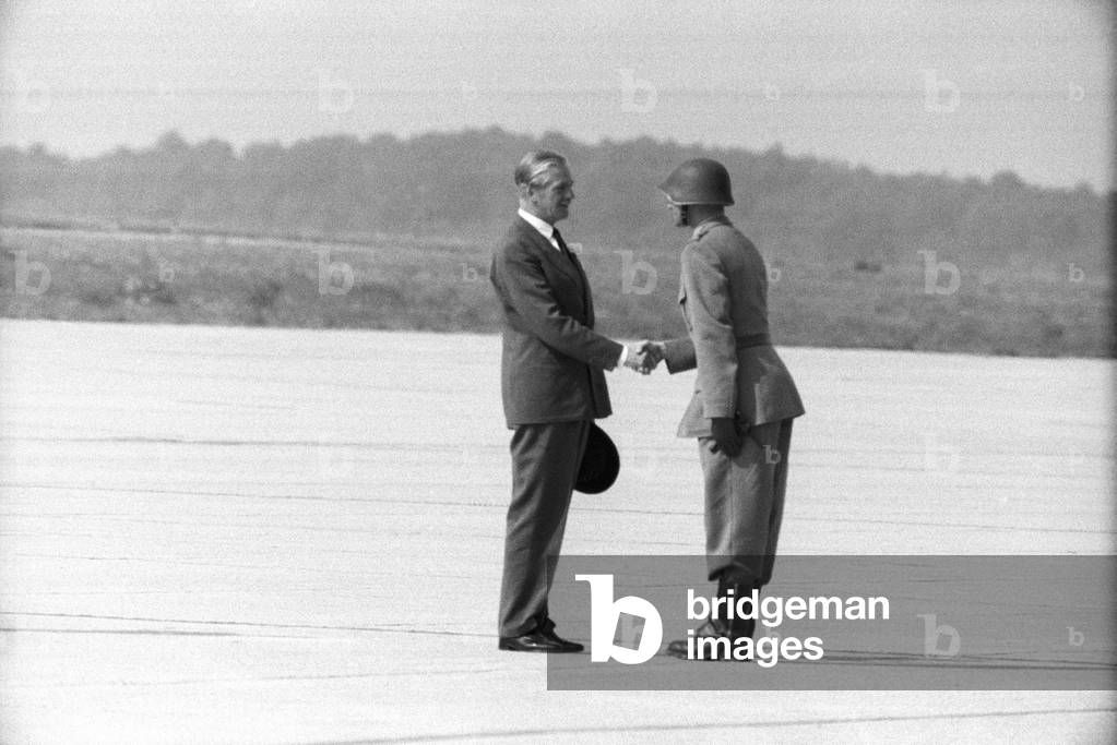 Anthony Eden shaking the hand of a military man at the Geneva Airport, Geneva, Switzerland