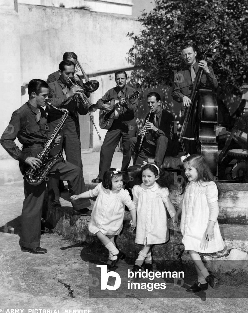 A U.S. military orchestra playing for some young girls, France