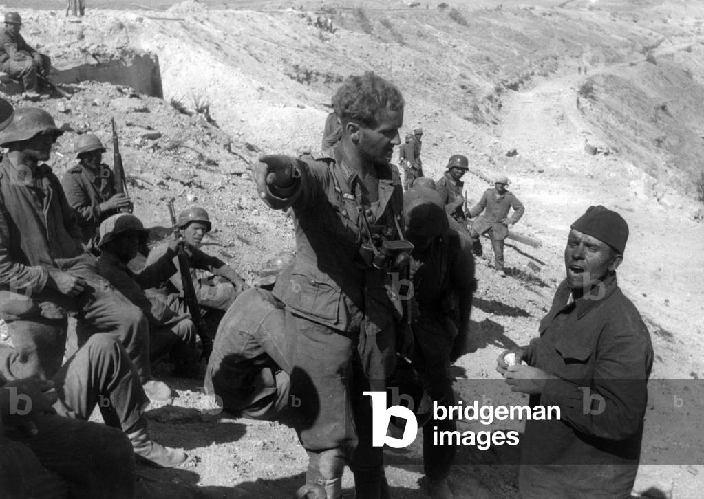A German soldier giving a prisoner directions