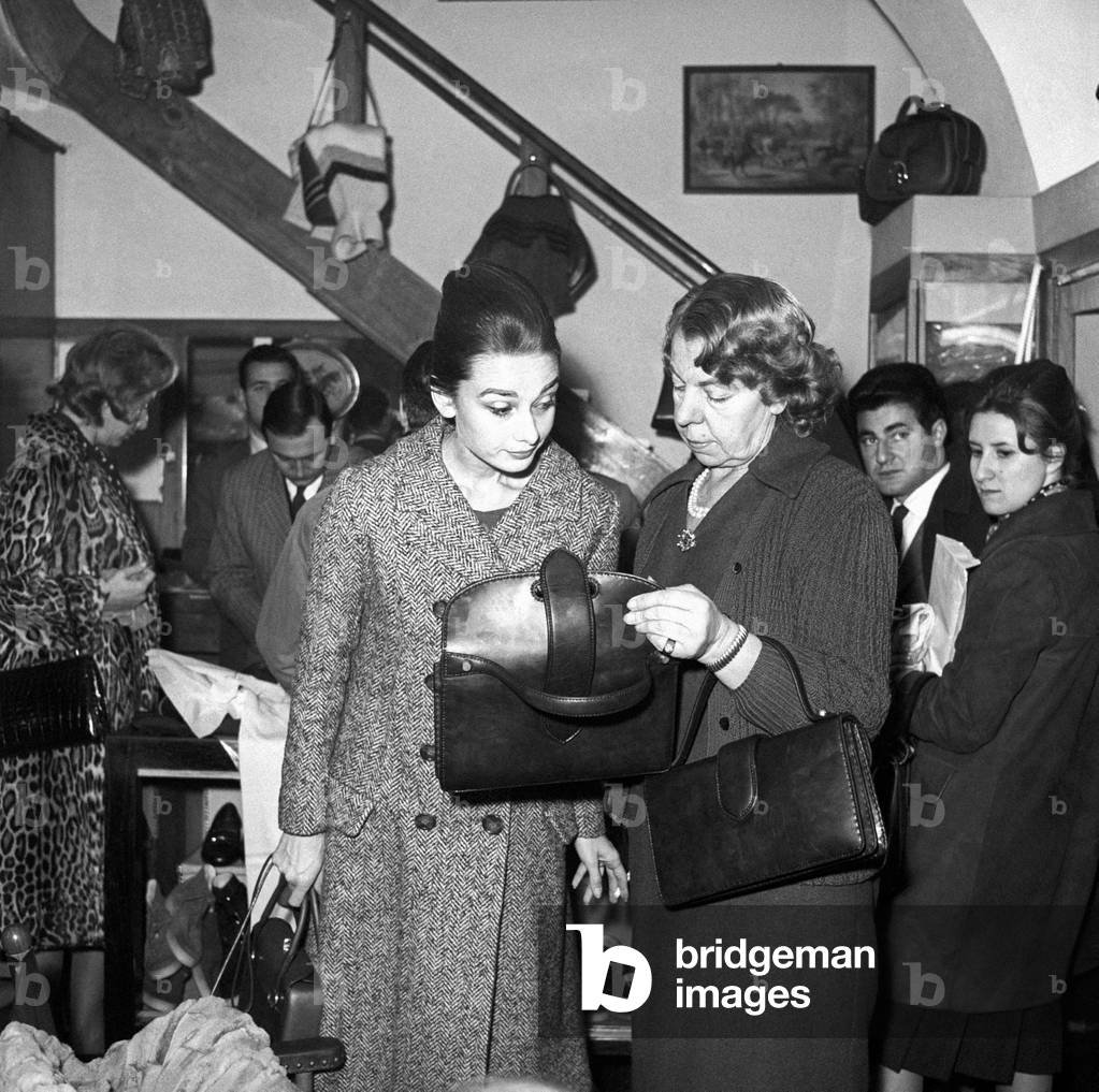 Audrey Hepburn checking a bag