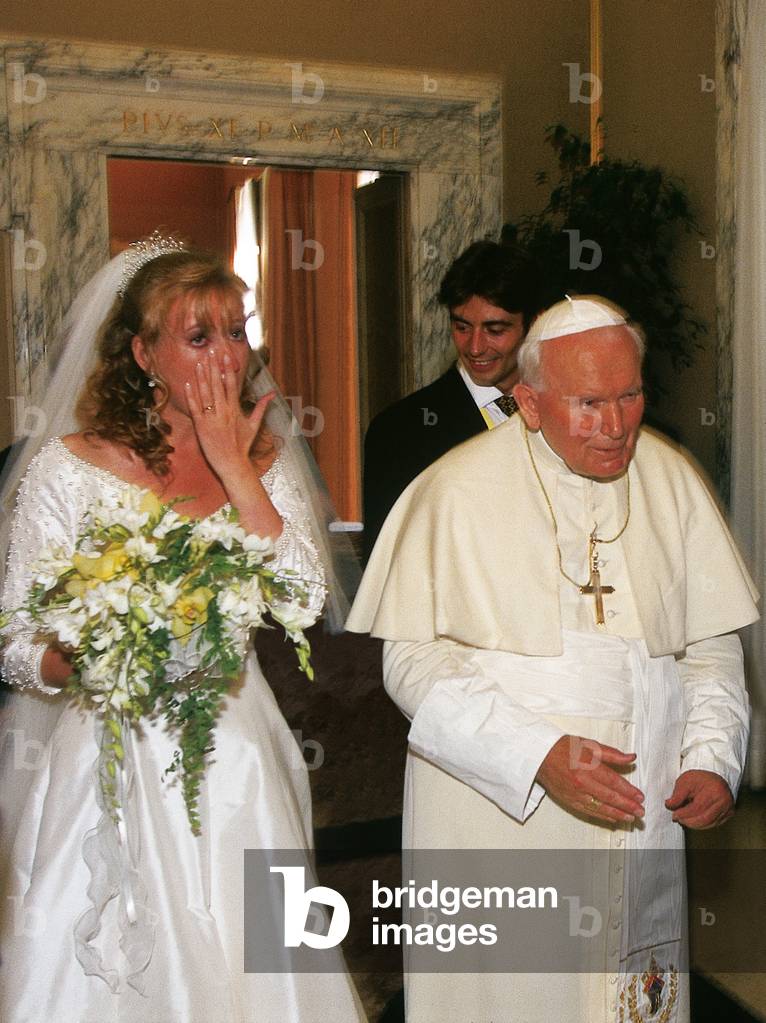 Pope John Paul II blessing a married couple