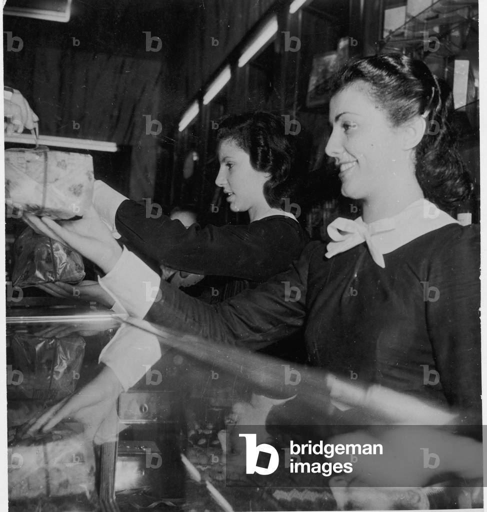 Smiling sale women in a confictionery