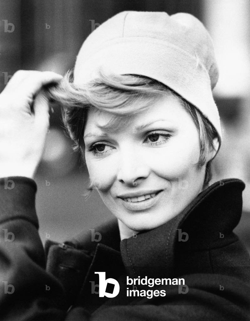 Scilla Gabel arranging her hair