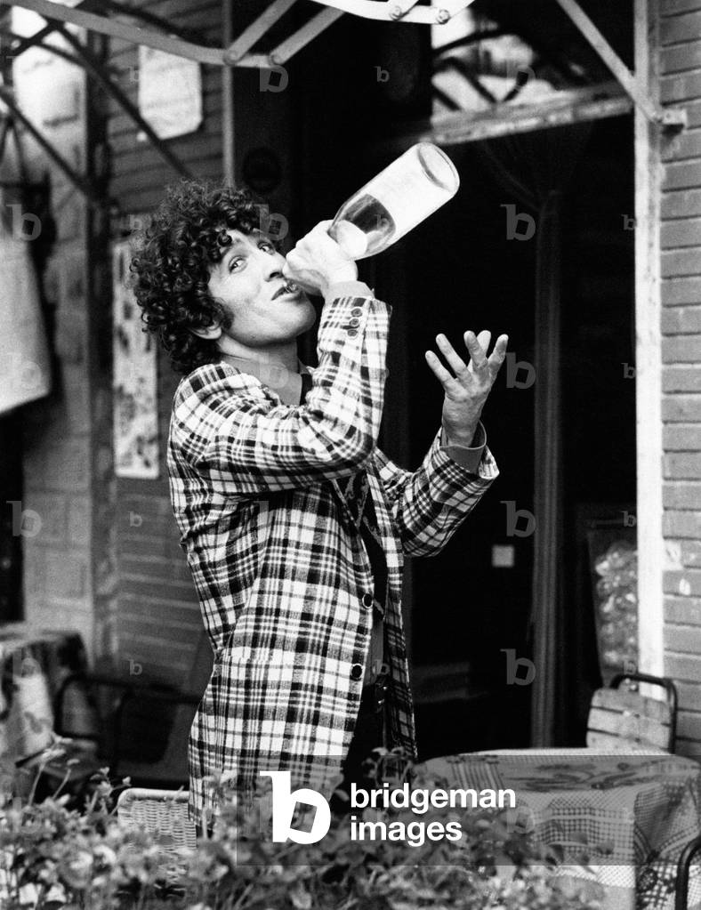 Ninetto Davoli drinking from a bottle