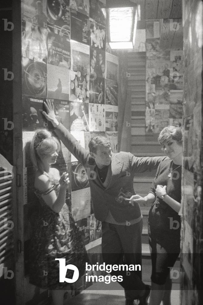 Young people in a room full of posters
