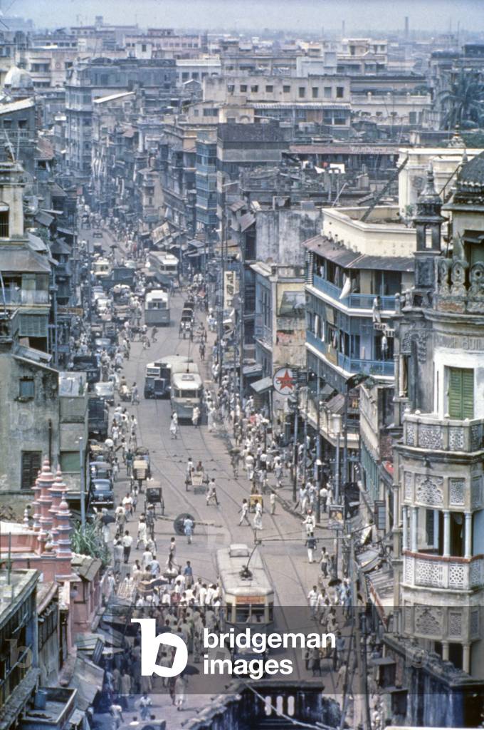 A trolleybus going through a street, Kolkata, India, 1962 (b/w photo)