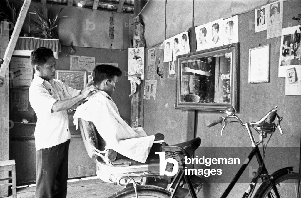 Thai hairdresser at work, Bangkok, 1961 (b/w photo)