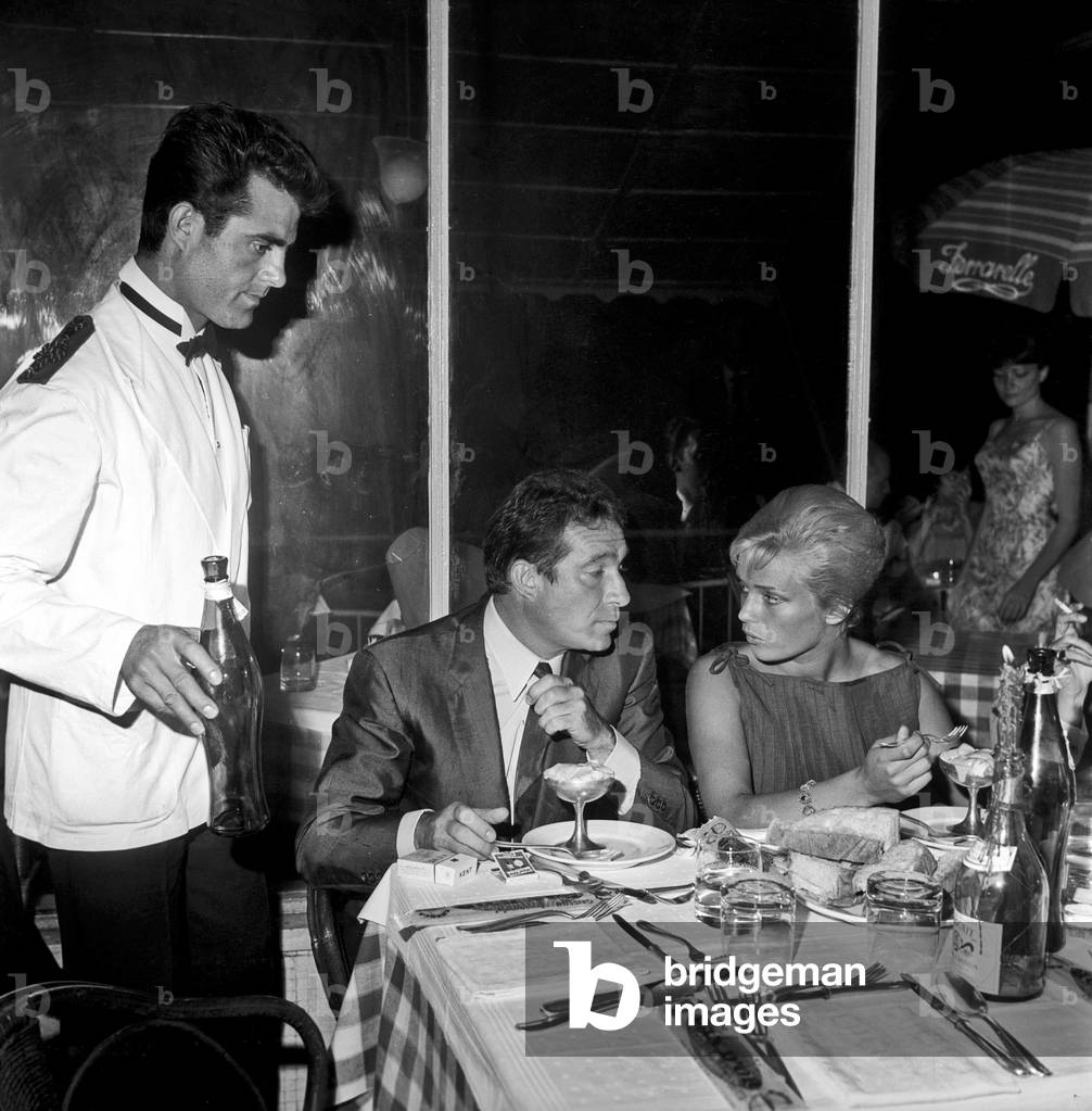 Ugo Tognazzi and Margarete Robsahm at a dinner, Rome, Italy, 1961 (b/w photo)