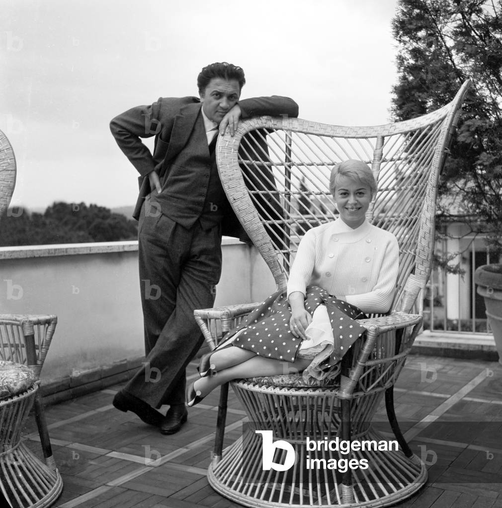 Giulietta Masina and Federico Fellini on a terrace, Italy, 1956 (b/w photo)