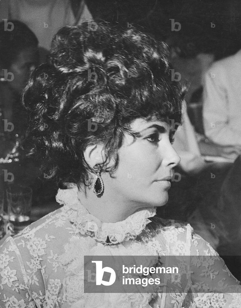 British-born American actress Liz Taylor attending the dancing party of Cicogna counts at Ca' Vendramin Calergi, Venice, Italy, 7th September 1967 (b/w photo)
