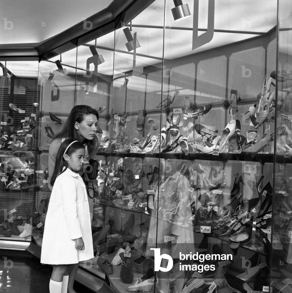 A woman watching the prices of the shoes, Italy