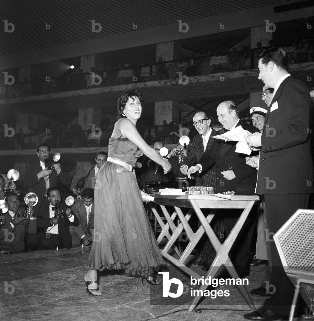 Anna Magnani getting the Maschere d'Argento award, Italy, 1955 (b/w photo)