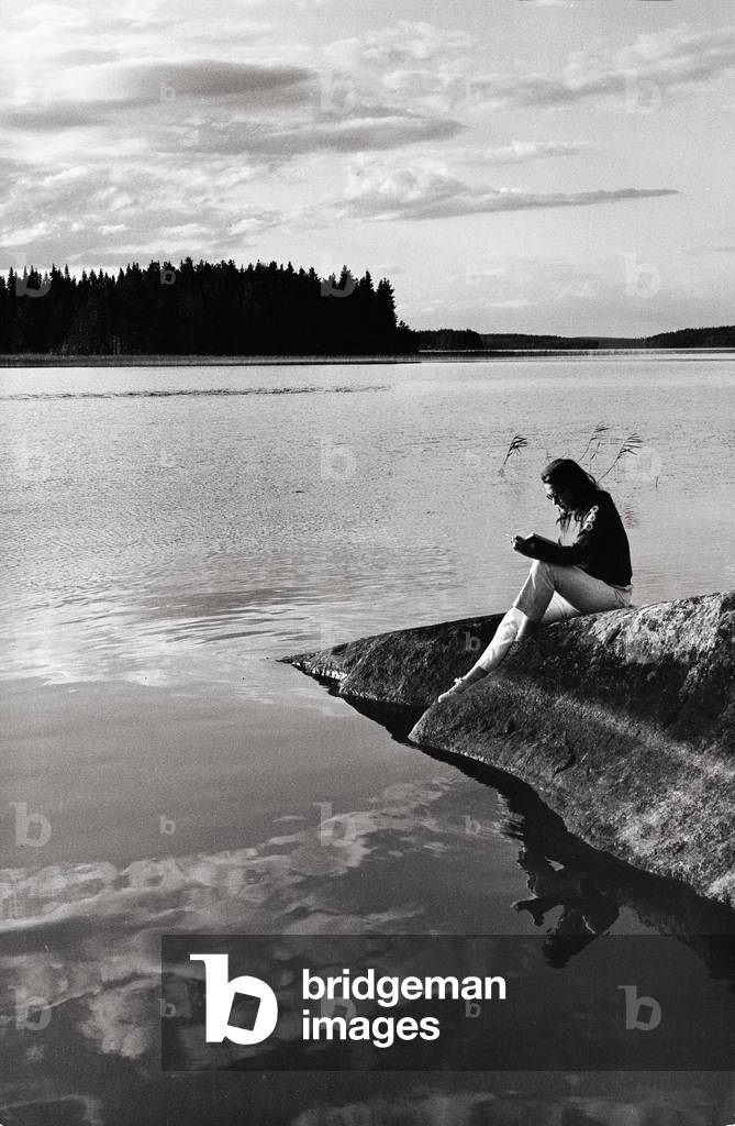 Girl on the shores of a lake in Finland, Finland, 1971 (b/w photo)