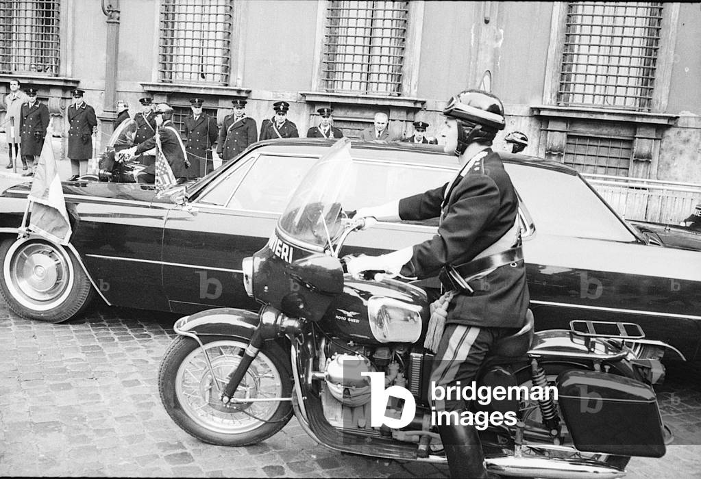 Richard Nixon's car escorted by Carabinieri riding moorbikes, Italy, 1969 (b/w photo)