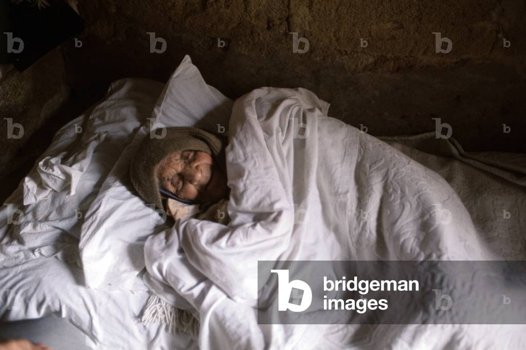 An old woman who escaped the earthquake, Italy, 1968 (b/w photo)