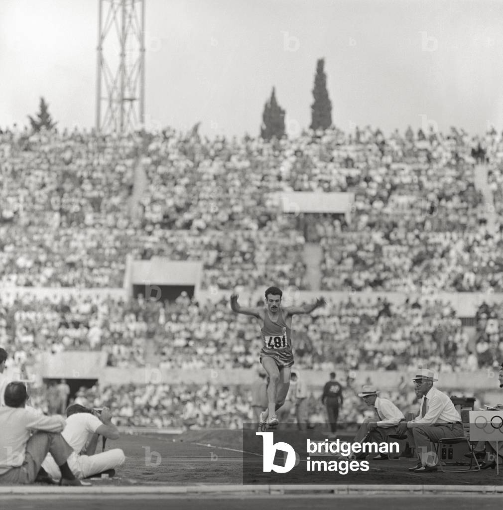 An Athlete occupied in triple jump to Rome Olympies, 1960 (b/w photo)