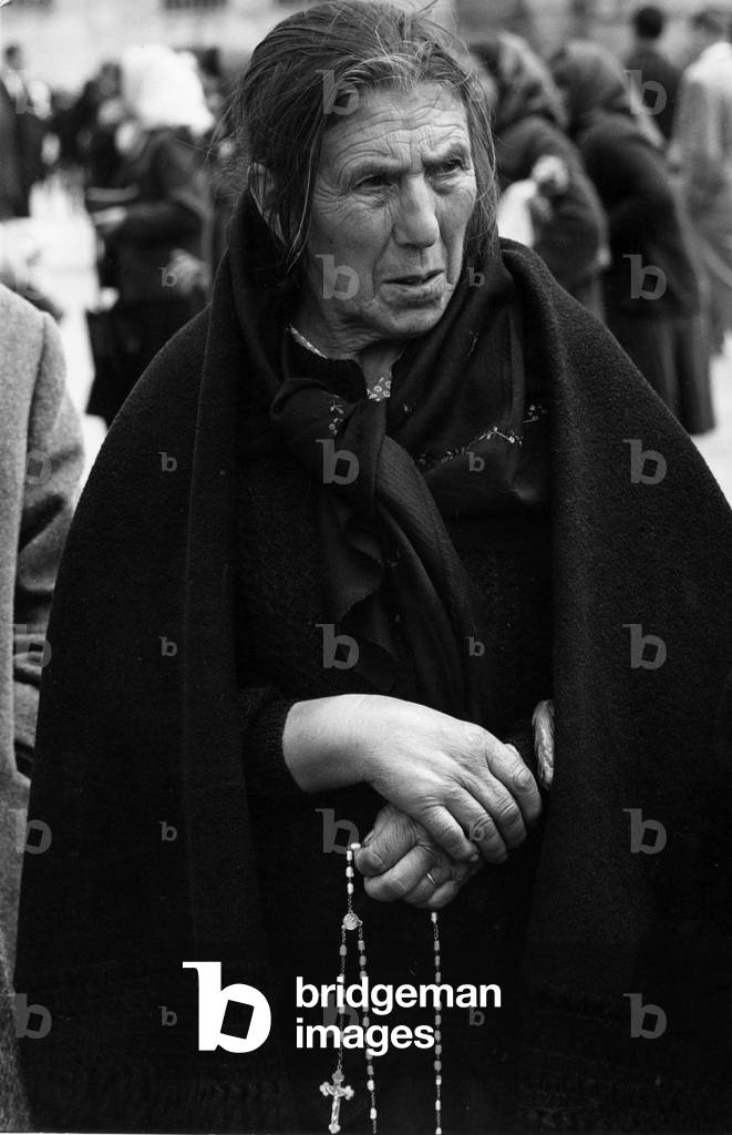 A woman with rosary in Fatima shrine