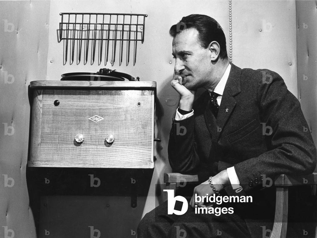 Nunzio Filogamo sitting beside a record player