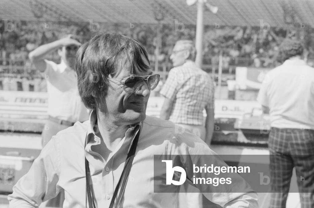 Bernie Ecclestone watching the qualifying sessions of the Italian Gran Prix, Italy, 1977 (b/w photo)