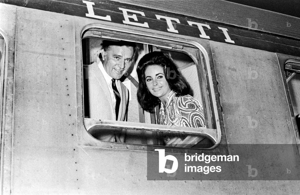 Richard Burton and Elizabeth Taylor at the train window, Rome, Italy, 1966 (b/w photo)