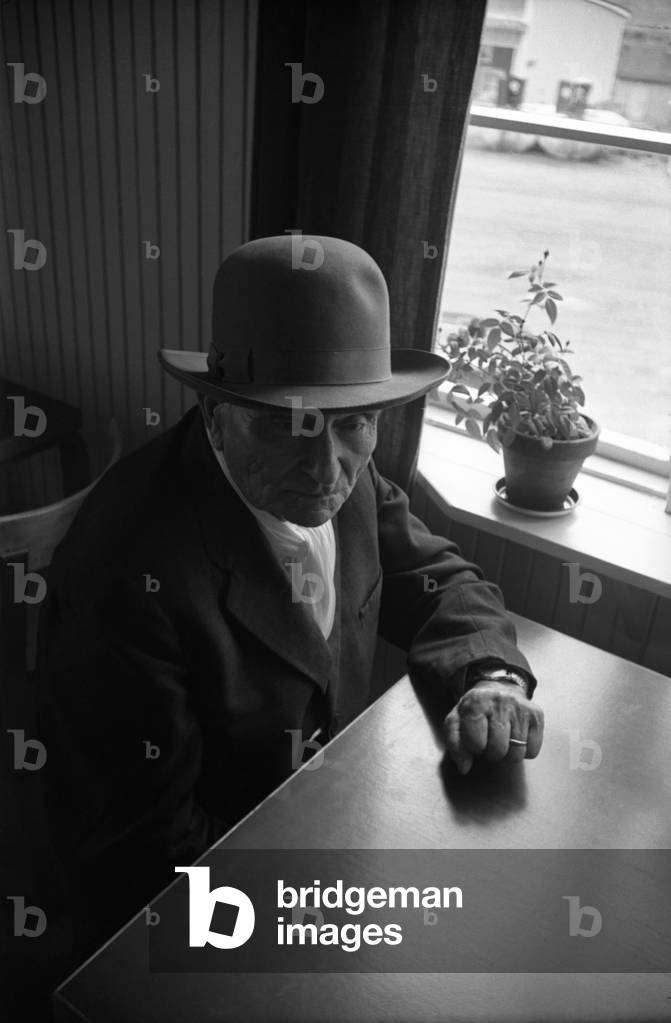 An old man sitting thoughtful, Finland, 1960s (b/w photo)