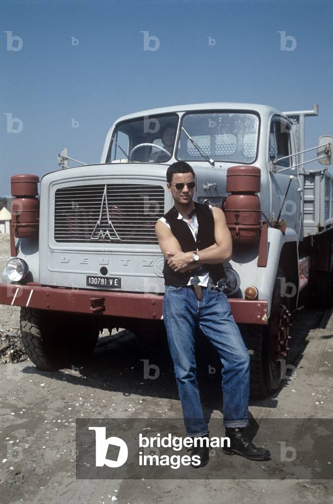 Nick Camen posing in front of a truck