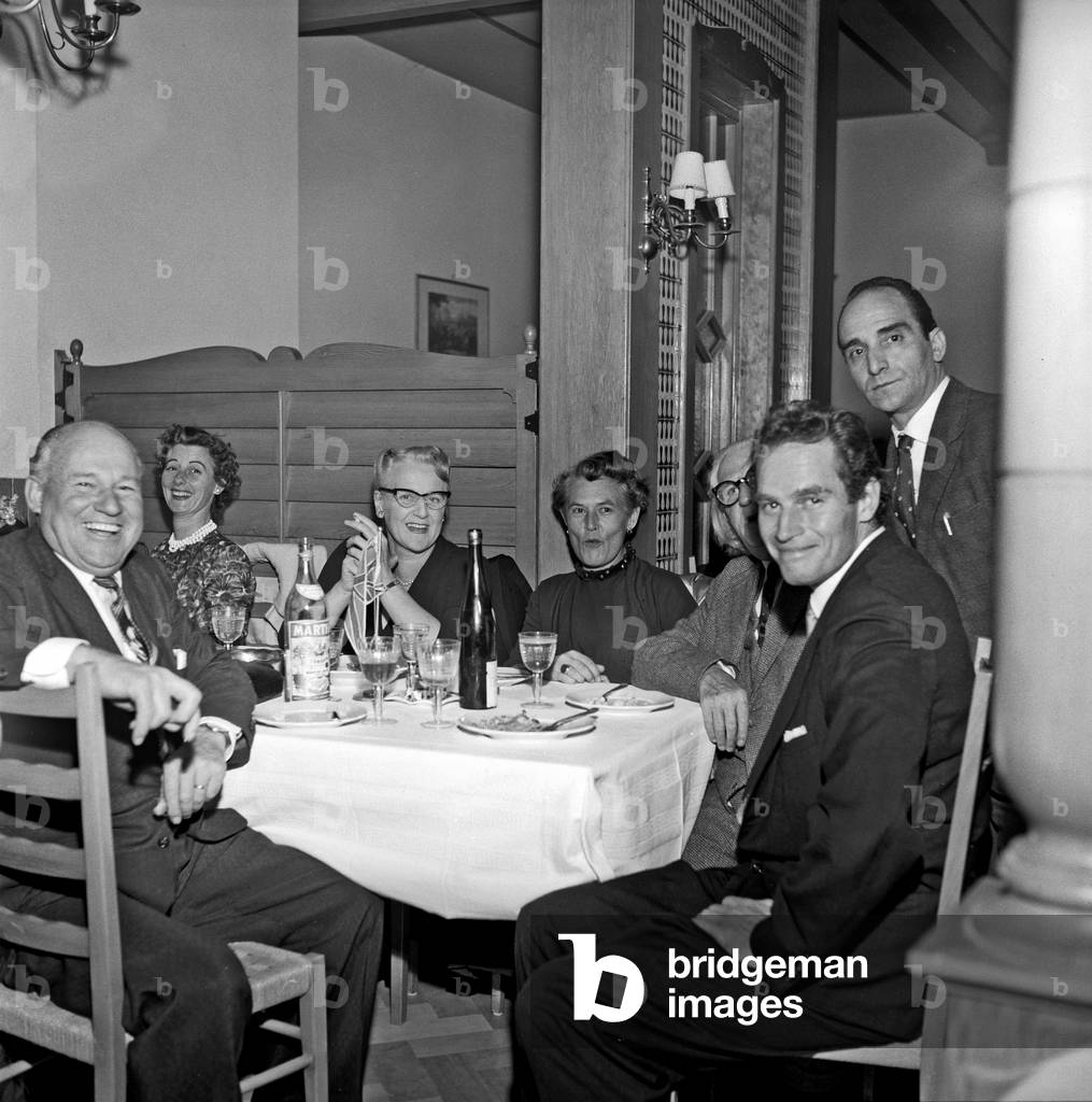 Charlton Heston sitting at the restaurant, Rome, Italy, 1959 (b/w photo)