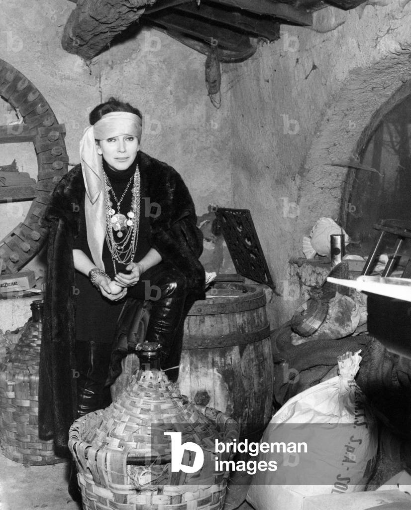 Valentina Cortese among the wine demijohns, Portofino, Italy, 1969