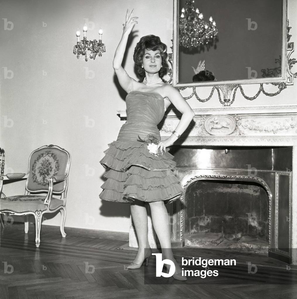 Silvana Pampanini trying on a dress by Valentino, Italy, 1956 (b/w photo)