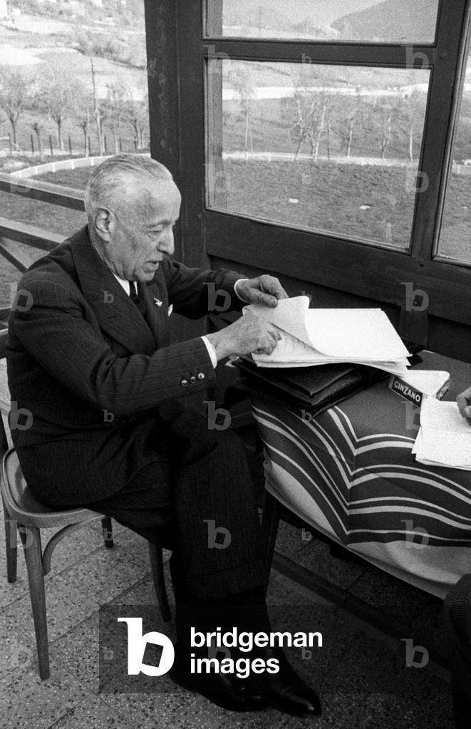 Alessandro Cagno leafing through some papers, Saint Vincent, Italy