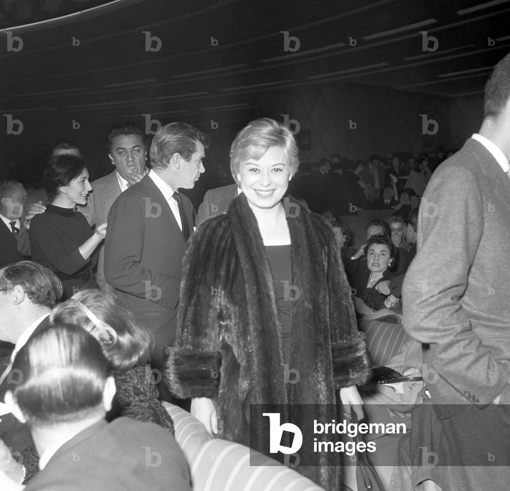 Giulietta Masina and Federico Fellini attending the premiere of the comedy L'adorabile Giulio, Italy, 1956 (b/w photo)