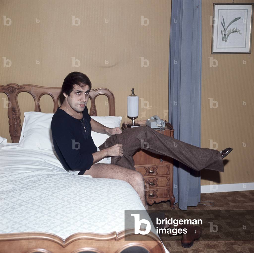 Adriano Celentano taking off his clothes