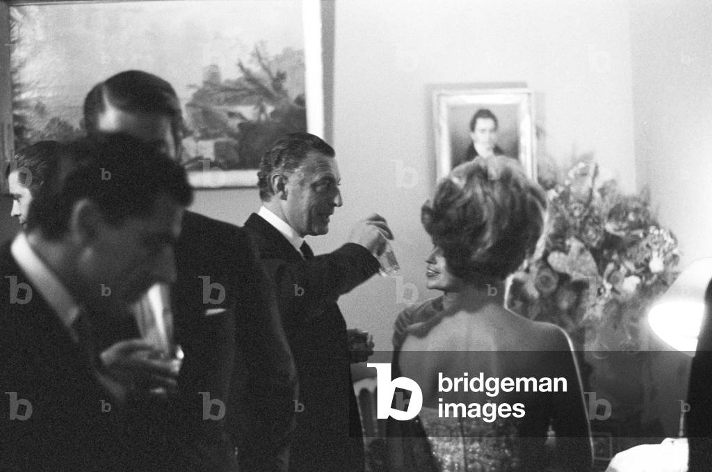 Gianni Agnelli attending a party at Pierre Cardin's fashion house, France, Paris, 1964 (b/w photo)