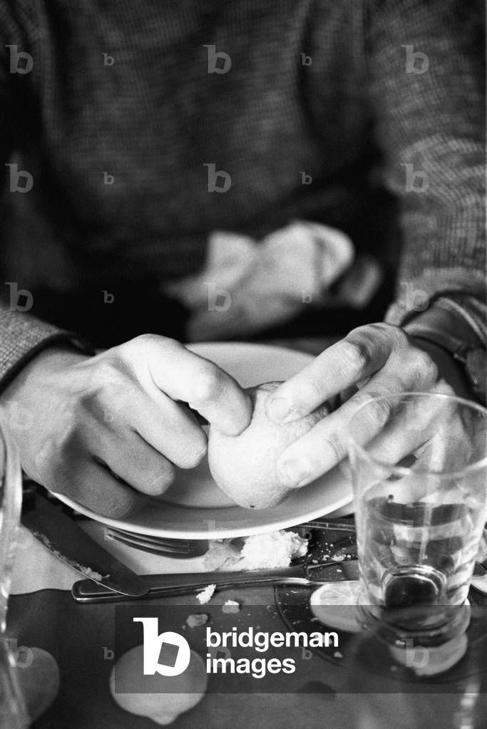 Uto Ughi peeling a Mandarin orange, Italy, 1970